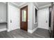 Mudroom with exterior door, dark wood storage cabinets, and granite countertops at 610 Valley Green Trce, Marietta, GA 30068
