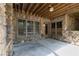 Covered outdoor patio is built with stone and natural wood materials at 610 Valley Green Trce, Marietta, GA 30068