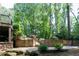 A backyard patio area featuring decorative stone retaining walls and a glimpse of the pool at 610 Valley Green Trce, Marietta, GA 30068