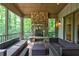 Charming screened porch with a stone fireplace, offering an ideal relaxation and entertainment space at 610 Valley Green Trce, Marietta, GA 30068