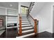 Elegant staircase with wood and iron railings, complemented by dark hardwood floors and built-in shelving at 610 Valley Green Trce, Marietta, GA 30068