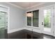 Sun room features wooden floors, two windows with shades, a door to a balcony, and a modern light fixture at 610 Valley Green Trce, Marietta, GA 30068
