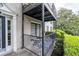 Outdoor patio featuring a table and seating, enclosed with a black railing and surrounded by greenery at 3440 Essex Ave # 103, Atlanta, GA 30339