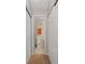 Hallway view of a well-lit bathroom with white tile flooring and an orange towel on a rack at 3440 Essex Ave # 103, Atlanta, GA 30339