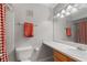Bright bathroom with a vanity, white countertop, light-wood cabinets, and red checkered shower curtain at 3440 Essex Ave # 103, Atlanta, GA 30339
