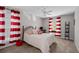 Comfortable bedroom with a metal bed frame, red-and-white striped curtains, and a ceiling fan at 3440 Essex Ave # 103, Atlanta, GA 30339