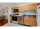 Functional kitchen featuring wood cabinets and appliances at 3440 Essex Ave # 103, Atlanta, GA 30339