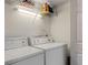 Utility room equipped with a side-by-side washing machine and dryer unit, plus overhead storage at 3440 Essex Ave # 103, Atlanta, GA 30339