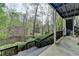 Spacious back deck overlooks a tranquil pond, surrounded by lush greenery and mature trees at 443 Lakeshore Dr, Berkeley Lake, GA 30096