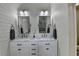 The stylish bathroom features double sinks, marble countertop, and neutral colors at 443 Lakeshore Dr, Berkeley Lake, GA 30096
