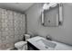 Bathroom featuring shower with patterned curtain, modern sink and mirror at 443 Lakeshore Dr, Berkeley Lake, GA 30096