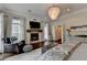 Spacious bedroom with fireplace, chandelier, and seating area for relaxing at 443 Lakeshore Dr, Berkeley Lake, GA 30096