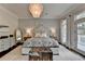 Stunning main bedroom boasts a decorative chandelier and a cozy rug at 443 Lakeshore Dr, Berkeley Lake, GA 30096
