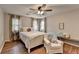 Cozy bedroom with hardwood floors, natural light, and comfortable seating area at 443 Lakeshore Dr, Berkeley Lake, GA 30096