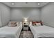 Bright bedroom featuring two twin beds with plush pillows, soft lighting, and a cozy rug at 443 Lakeshore Dr, Berkeley Lake, GA 30096