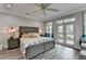 Bedroom featuring a spacious layout, wood-look floors, and a door to a private outdoor deck at 443 Lakeshore Dr, Berkeley Lake, GA 30096