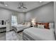 Comfortable bedroom featuring two beds, a vanity, and a neutral color scheme at 443 Lakeshore Dr, Berkeley Lake, GA 30096
