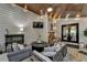Relaxing covered patio featuring an outdoor seating area, and wood plank ceiling at 443 Lakeshore Dr, Berkeley Lake, GA 30096