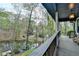 View from the deck showcases a tranquil pond and wooded surroundings at 443 Lakeshore Dr, Berkeley Lake, GA 30096