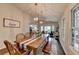 Spacious dining room featuring rustic table and access to a cozy sitting area at 443 Lakeshore Dr, Berkeley Lake, GA 30096