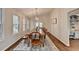 Open concept dining room with natural lighting, hardwood floors and neutral decor at 443 Lakeshore Dr, Berkeley Lake, GA 30096