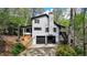 Beautiful home featuring a two-car garage, stone-paved stairs, and black-framed windows at 443 Lakeshore Dr, Berkeley Lake, GA 30096