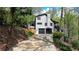 Beautiful home featuring a two-car garage, stone-paved stairs, and black-framed windows at 443 Lakeshore Dr, Berkeley Lake, GA 30096