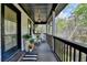 Charming covered front porch with wood floors, white railings, and seating area at 443 Lakeshore Dr, Berkeley Lake, GA 30096