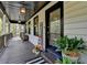 Welcoming front porch with a cozy atmosphere, decorative plants, and a stained-glass front door at 443 Lakeshore Dr, Berkeley Lake, GA 30096