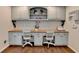Dedicated home office space with built-in desks, cabinetry, and wood floors at 443 Lakeshore Dr, Berkeley Lake, GA 30096