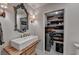 Charming laundry room features rustic wood accent wall, modern washer, and farmhouse-style sink at 443 Lakeshore Dr, Berkeley Lake, GA 30096