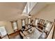 Spacious living room with high ceilings, fireplace, large windows, and comfortable seating area at 443 Lakeshore Dr, Berkeley Lake, GA 30096