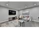 Cozy living room with plush gray sofa, rug, and entertainment center, creating a relaxed space at 443 Lakeshore Dr, Berkeley Lake, GA 30096