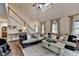 Open living room with hardwood floors, comfortable seating, and staircase access at 443 Lakeshore Dr, Berkeley Lake, GA 30096
