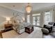 Serene main bedroom boasts a chandelier, shiplap wall, and French doors to the outside at 443 Lakeshore Dr, Berkeley Lake, GA 30096