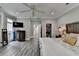 Spacious main bedroom with wood-look floors, a walk-in closet, and bright, natural light at 443 Lakeshore Dr, Berkeley Lake, GA 30096