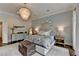 Beautifully decorated main bedroom offers a statement chandelier and shiplap wall at 443 Lakeshore Dr, Berkeley Lake, GA 30096