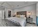 Spacious main bedroom with wood-look floors, a walk-in closet, and a king-sized bed at 443 Lakeshore Dr, Berkeley Lake, GA 30096