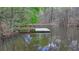 Charming pond featuring a tranquil dock area, adding to the property's peaceful ambiance at 443 Lakeshore Dr, Berkeley Lake, GA 30096