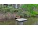 Picturesque waterfront home featuring a scenic pond with dock, creating a private retreat at 443 Lakeshore Dr, Berkeley Lake, GA 30096