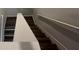 Neutral staircase with wood floors and white railing at 8664 Webb Rd, Riverdale, GA 30274