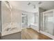 Bathroom with dual vanity, large tub, glass enclosed shower, tile floor, and recessed lights at 172 Mill Creek Dr, Canton, GA 30115