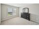 Cozy bedroom with neutral carpet, window, and dark dresser with mirror at 172 Mill Creek Dr, Canton, GA 30115