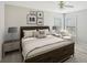 Cozy bedroom with ceiling fan, bedside table, and reading chair with lots of natural light at 172 Mill Creek Dr, Canton, GA 30115