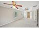 Bright bedroom with plush carpet, ceiling fans, and an open doorway to another room at 172 Mill Creek Dr, Canton, GA 30115
