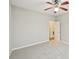 A simple bedroom with carpet, a ceiling fan, and a door to the hallway at 172 Mill Creek Dr, Canton, GA 30115