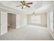 Large bedroom featuring neutral walls, plush carpet, ceiling fan, and abundant natural light at 172 Mill Creek Dr, Canton, GA 30115