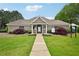 Community clubhouse featuring a manicured lawn, elegant landscaping and an inviting entrance at 172 Mill Creek Dr, Canton, GA 30115