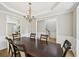 Spacious dining room featuring hardwood floors, crown molding, and elegant chandelier at 172 Mill Creek Dr, Canton, GA 30115
