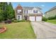 Charming two-story home with brick accents, lush lawn, and a two-car garage at 172 Mill Creek Dr, Canton, GA 30115
